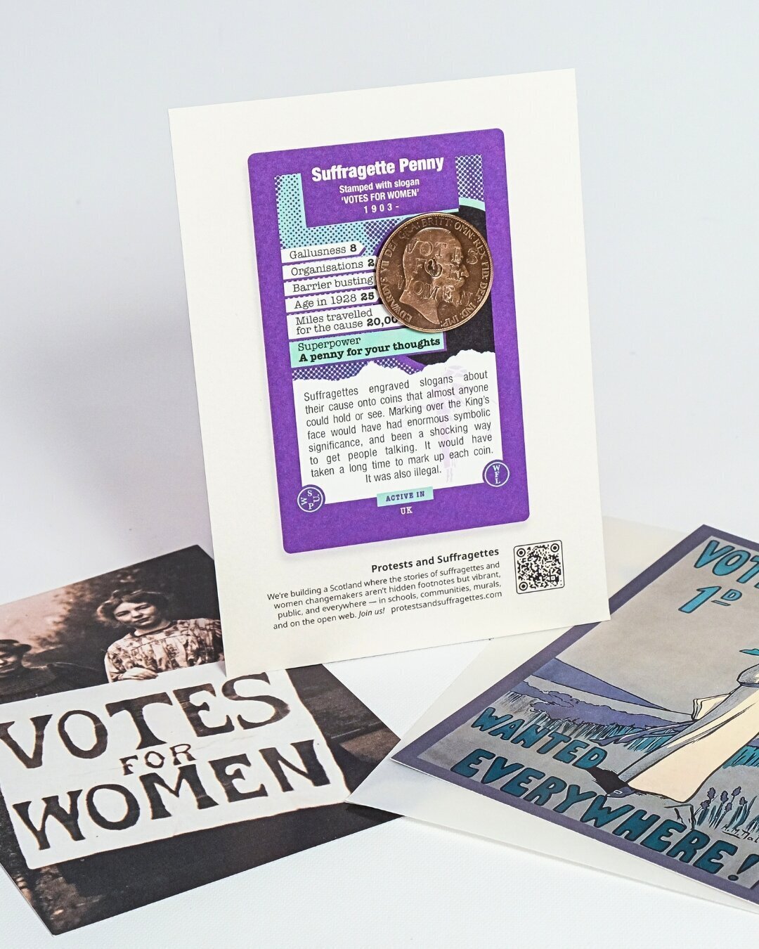 A hand holding a replica Suffragette Penny.